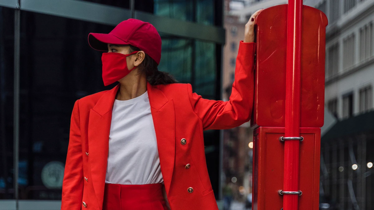 Woman in a red blazer, red trousers and red cap over a white T-shirt on a city street Color-coded casual cosplay example: a red blazer, red trousers and red cap over a plain white T-shirt, worn on a city sidewalk