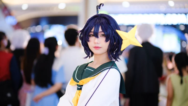 Cosplay for Beginners: A 4-Week Plan for Your First Build 1 Cosplay for beginners example: a cosplayer in a white sailor-collar school uniform and a short dark wig with a star clip at a busy convention