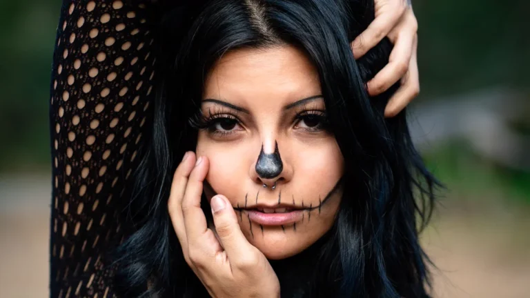 Halloween Makeup Ideas: 8 Easy Looks by Skill Level 1 Halloween makeup ideas in action: a black skull nose and stitched skeleton mouth drawn with liner on a woman with dark hair