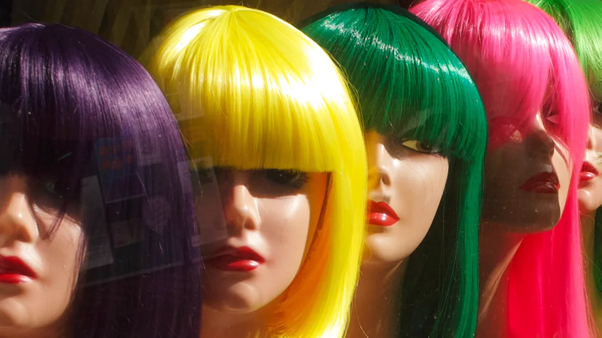 Purple, yellow, green and pink bob wigs with blunt bangs on mannequin heads How to style a cosplay wig starts on a head form: purple, yellow, green and pink synthetic bob wigs with blunt bangs on mannequin heads